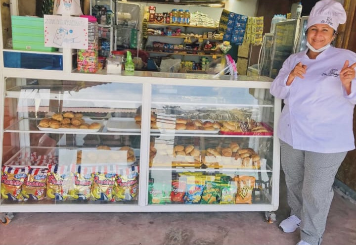 Marlene smiling in front of her family-owned business on the Jambeli Archipelago.